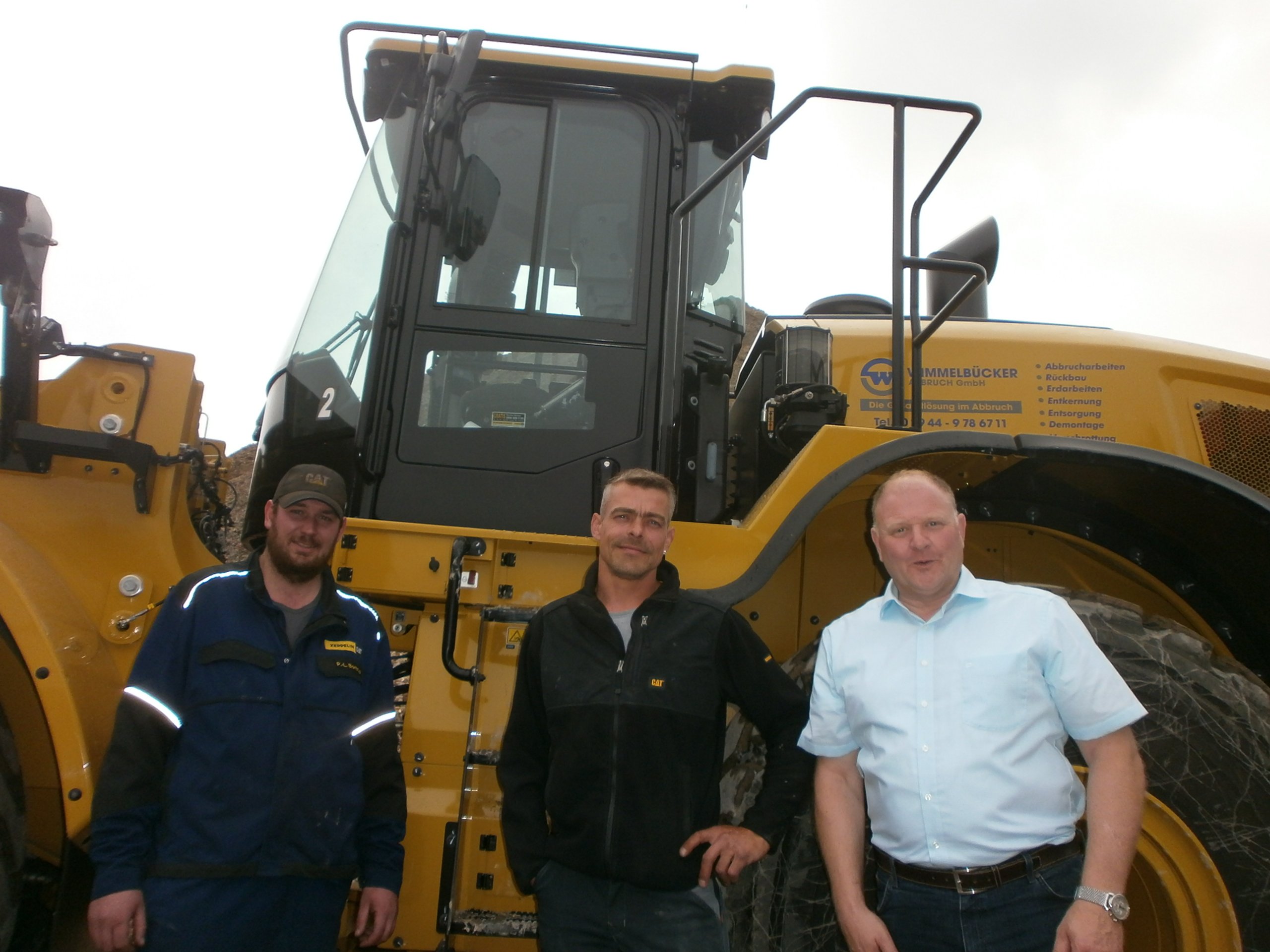 Philipp-Louis Bontrup, Servicetechniker, Georg Berken, Radladerfahrer, und Markus Knippschild, leitender Verkaufsrepräsentant, bei der Inbetriebnahme der Baumaschine (von links). Quelle: Zeppelin