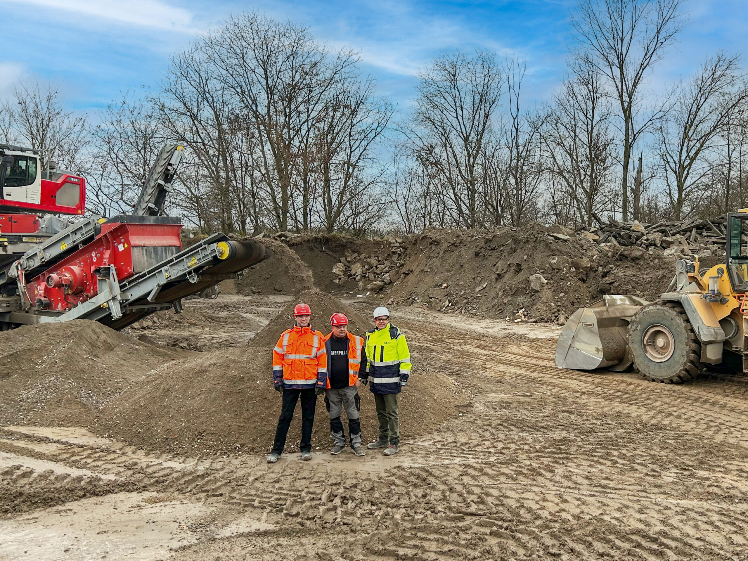 Thomas Atzler, Geschäftsführer der RWG I Schicht (li) mit Stefan Heger, Geschäftsführer der Heidelberg Materials Mineralik (re) und Bernhard Noack am neuen Recycling-Standort in Niederlehme. Copyright: Heidelberg Materials AG I Berit Weldner